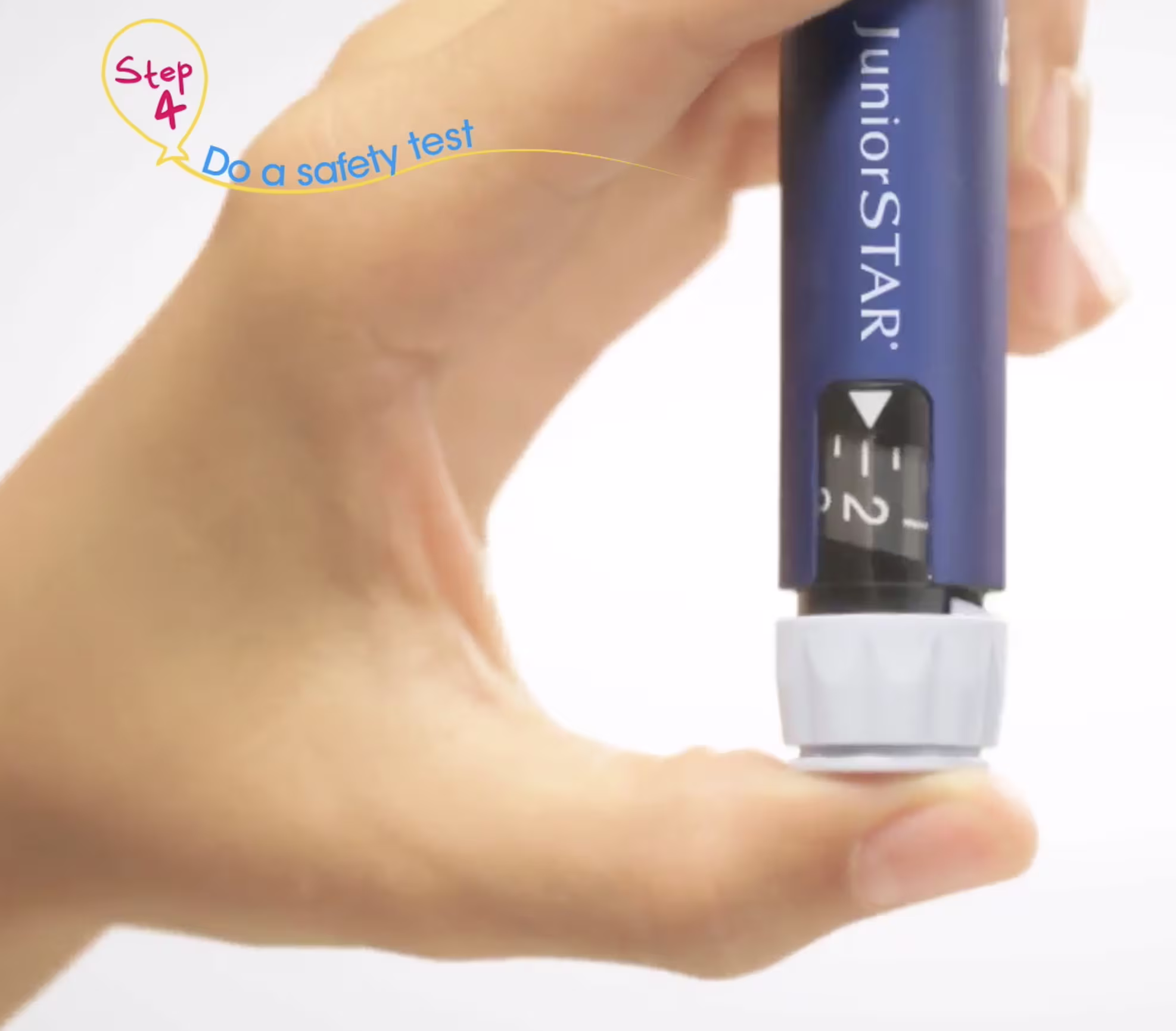 Close-up of a hand holding an insulin pen upright with the dosage window visible.